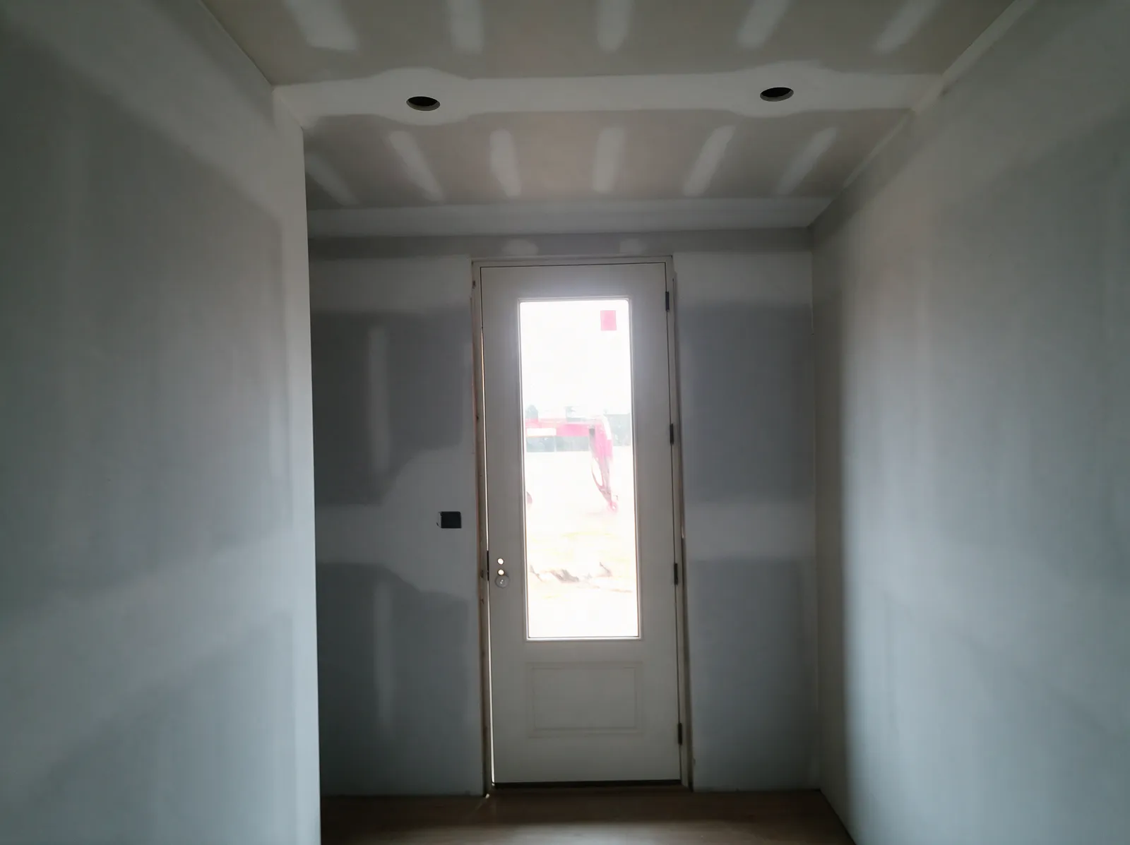 Finished hallway with taped and primed drywall